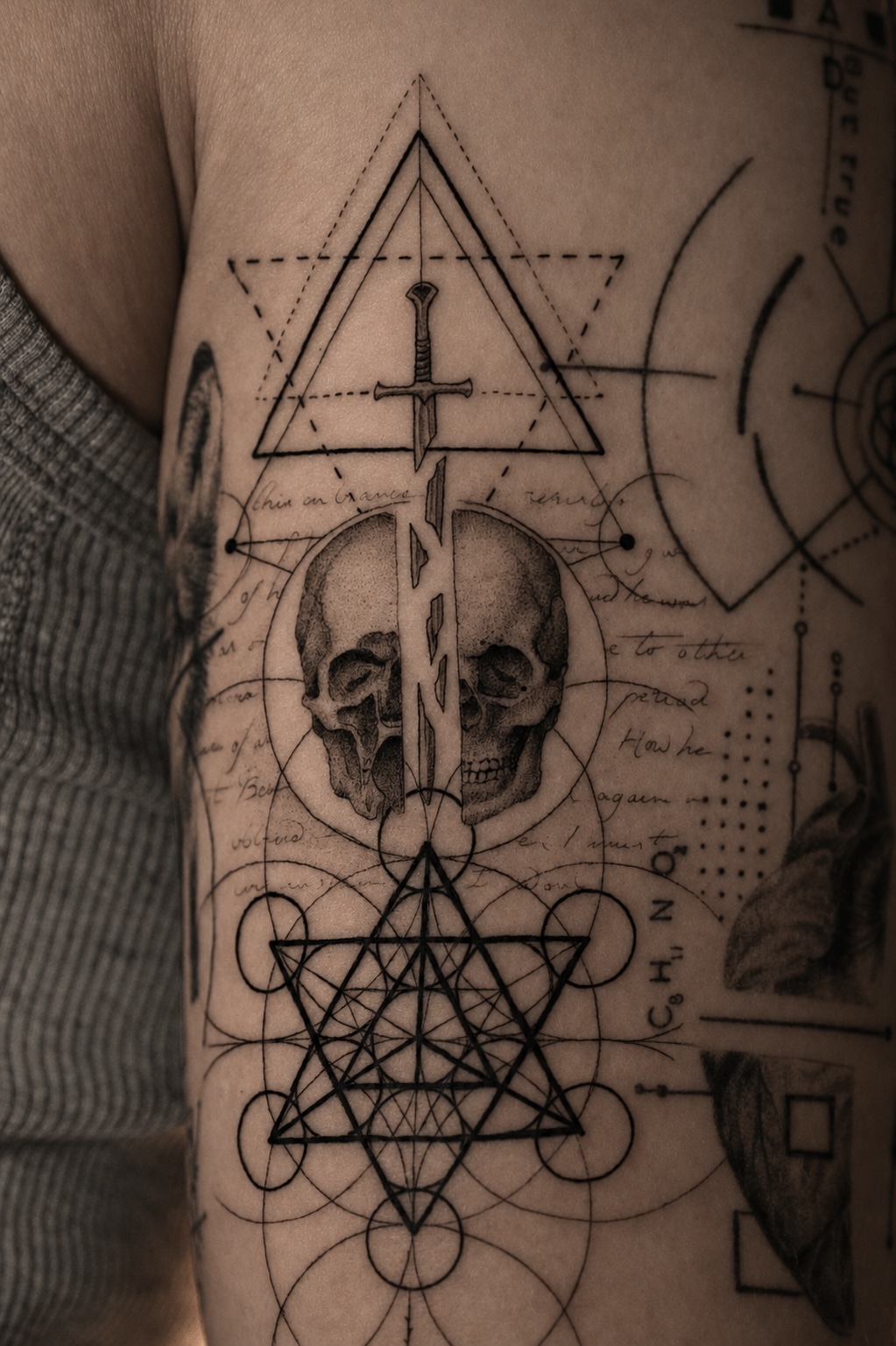 Geometric and sacred symbol sleeve detail